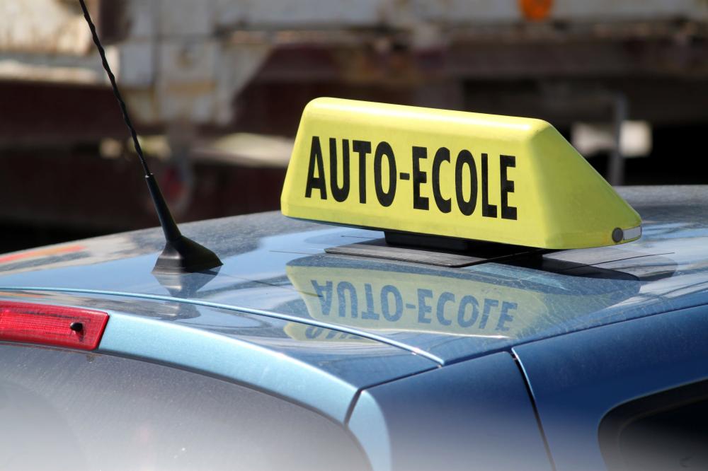 Signe auto-école au dessus d'une voiture